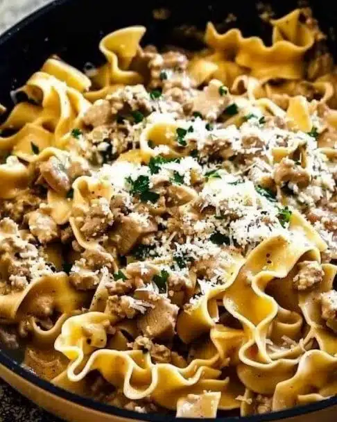 Delicious creamy turkey stroganoff served over egg noodles with fresh herbs