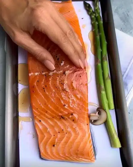 Honey mustard salmon fillet with mushrooms and asparagus on a plate.