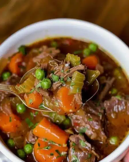 Delicious Instant Pot beef stew served in a bowl with fresh herbs.