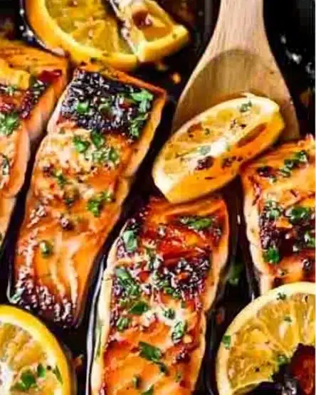Delicious orange glazed salmon dish garnished with fresh herbs.