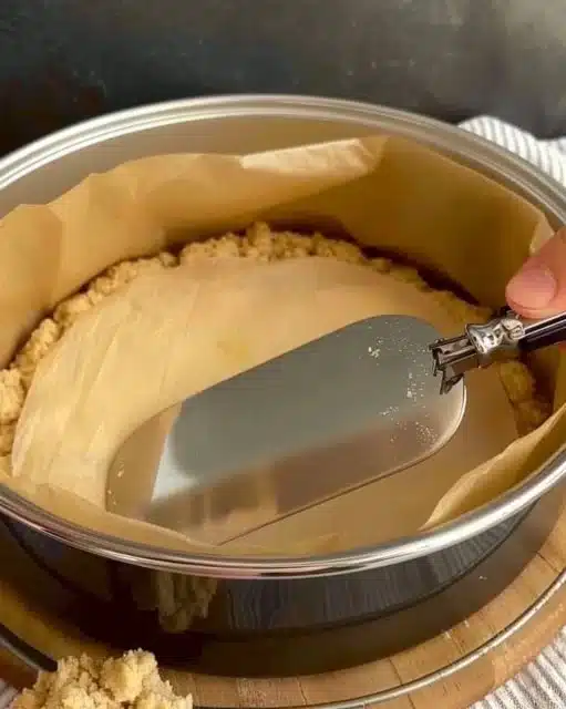 Freshly baked apple crumb cake with a buttery crumb topping on a wooden table