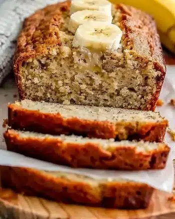 Moist and delicious homemade banana bread on a wooden table