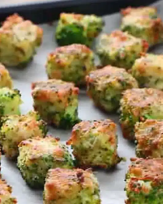 Crispy Broccoli Tots fresh out of the oven, served with a dipping sauce.