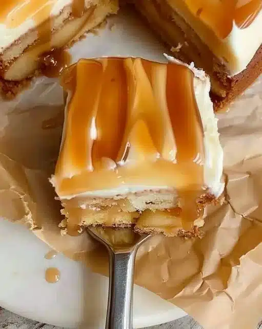 Delicious Caramel Apple Cake topped with caramel drizzle and apple slices