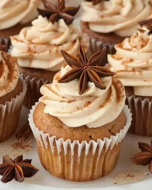 Chai latte cupcakes topped with creamy frosting and spiced decor.