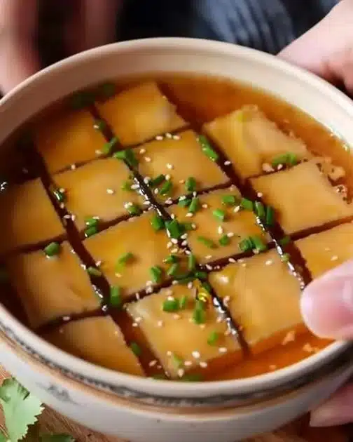 Delicious Chinese steamed egg served in a bowl garnished with green onions