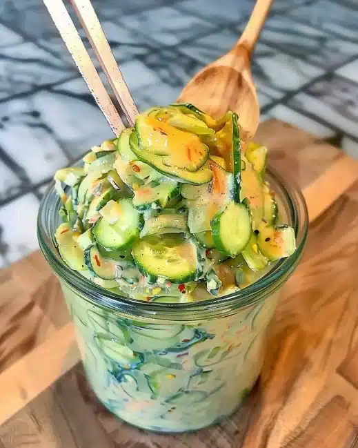 Creamy Asian cucumber salad with vibrant vegetables and rich dressing.