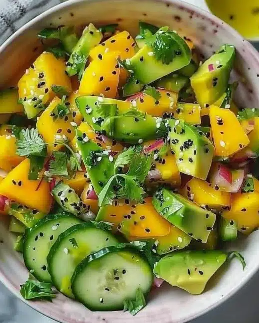 Cucumber Mango Avocado Salad with fresh ingredients served in a bowl.