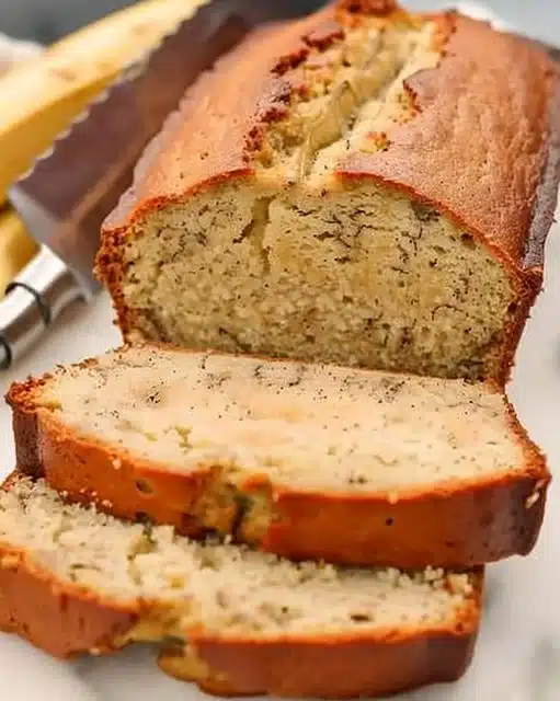 Slice of homemade buttermilk banana bread on a wooden board