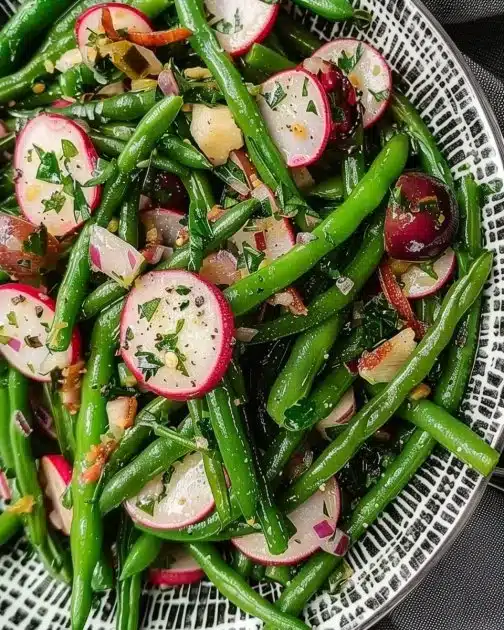 Delicious French Green Bean Salad topped with vinaigrette and fresh herbs