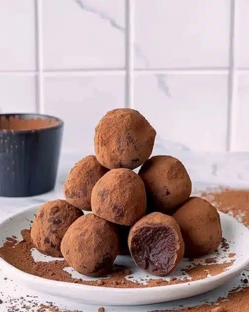 Fudgy dark chocolate sweet potato truffles arranged on a plate.