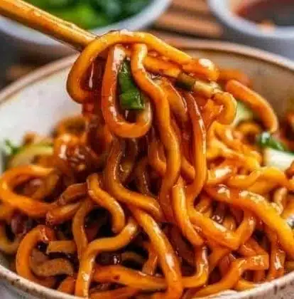 Plate of grilled udon noodles with vegetables and sauce