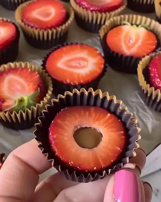 Healthy strawberry peanut butter cups stacked on a plate