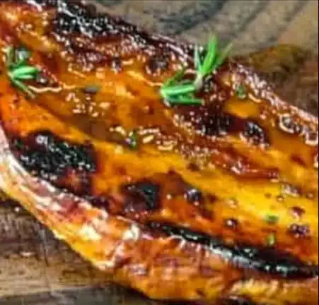 Delicious honey butter roasted sweet potatoes garnished for serving.