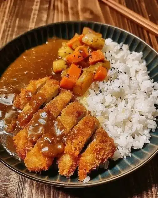 Delicious Japanese Pork Katsu Curry served with rice and garnished.