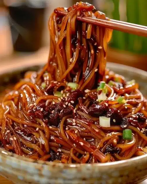 Bowl of Jajangmyeon, authentic Korean black bean noodles with savory sauce.