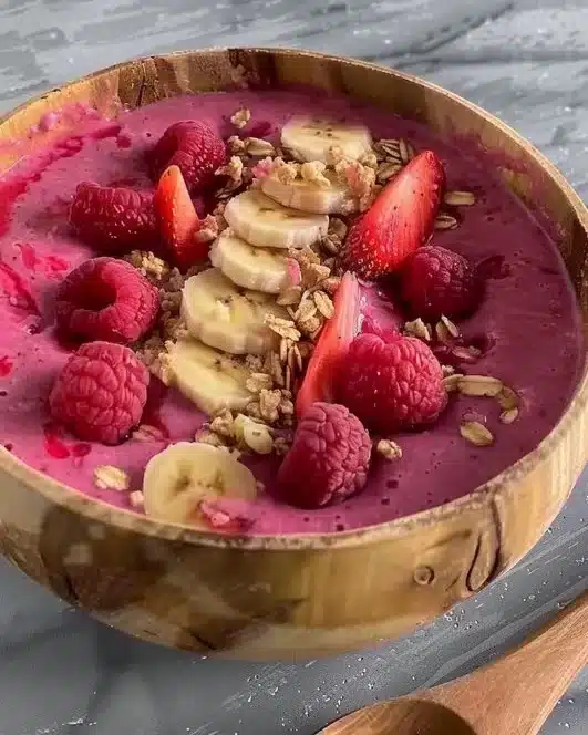 Low-calorie smoothie bowl topped with fresh fruits and seeds.