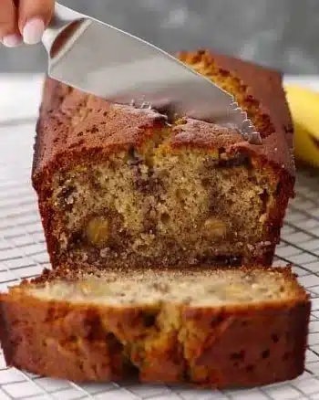 Slice of delicious one bowl banana bread on a wooden table