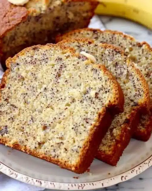 Loaf of perfect banana bread with slices on a wooden cutting board
