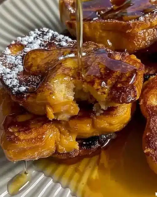 Deliciously prepared Pumpkin French Toast topped with maple syrup and cinnamon.