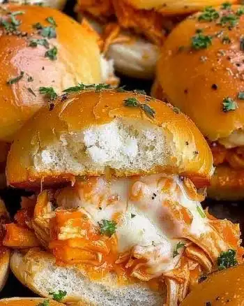 Spicy Buffalo Chicken Sliders with sauce and toppings served on a platter