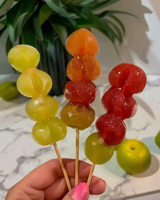 Colorful Tanghulu, a traditional Chinese candied fruit on a stick, displayed beautifully.