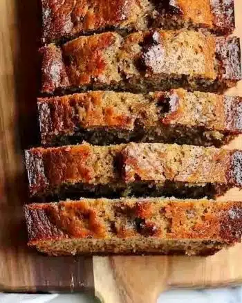 Deliciously moist ultimate banana bread loaf on a wooden table