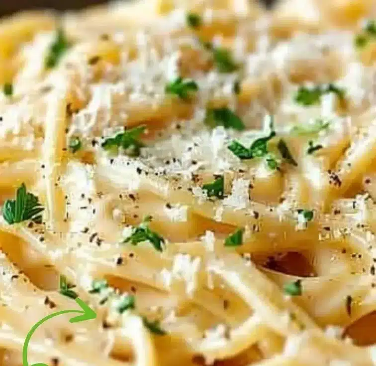Cheesy garlic parmesan spaghetti served in a bowl garnished with parsley