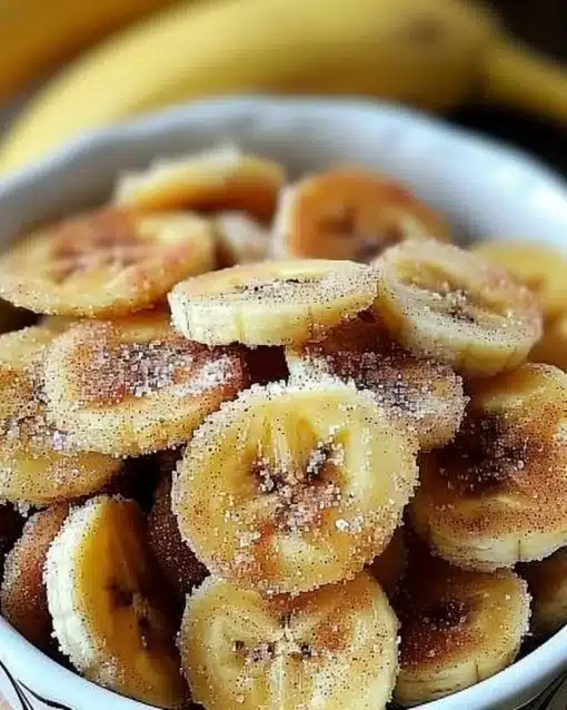 Crispy cinnamon sugar banana chips in a bowl, healthy snack option.