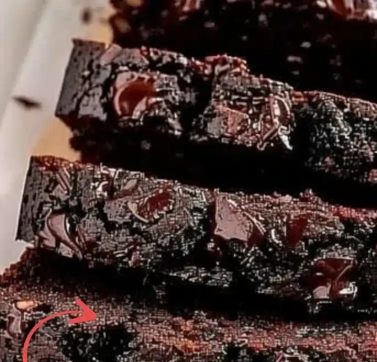 Slice of double chocolate banana bread with chocolate chips on a wooden board