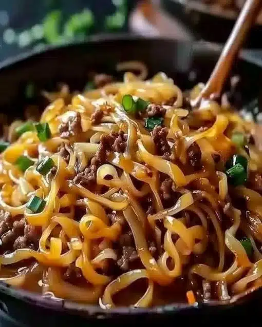 Bowl of easy Mongolian ground beef noodles topped with green onions
