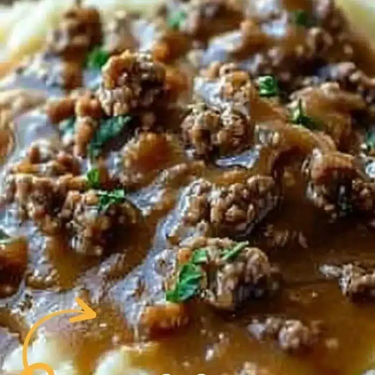Delicious hamburger gravy served over creamy mashed potatoes