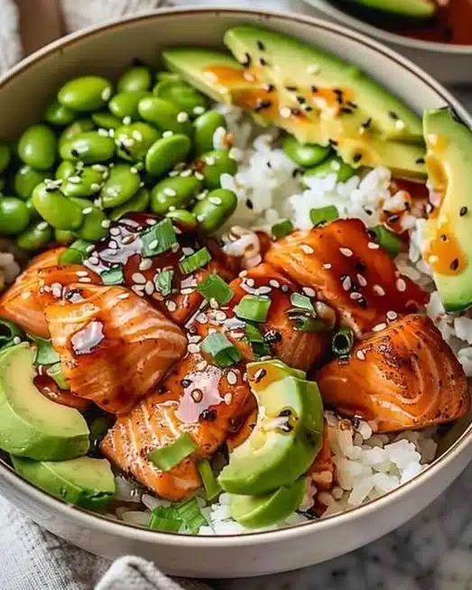 A vibrant bowl of Honey Sriracha Salmon with rice and vegetables