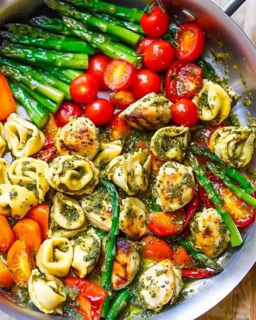 One-Pan Pesto Chicken with Tortellini and colorful veggies ready to serve