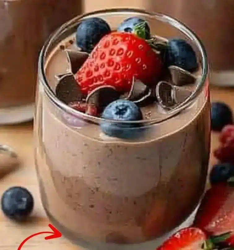 Delicious bowl of protein pudding topped with fresh berries and nuts