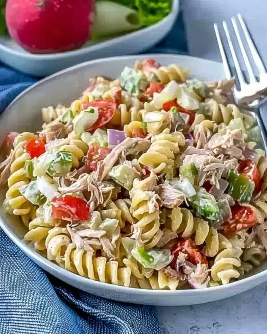 Delicious Tuna Pasta Salad with vegetables and dressing served in a bowl