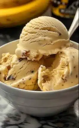 A bowl of homemade banana ice cream topped with sliced bananas