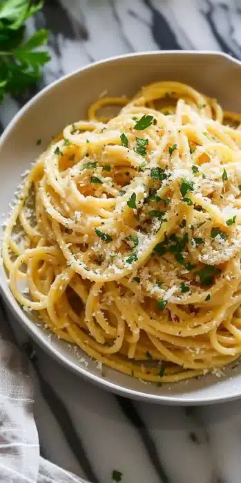 Delicious Garlic Parmesan Pasta topped with herbs and cheese