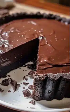 Delicious chocolate tart topped with chocolate shavings and berries