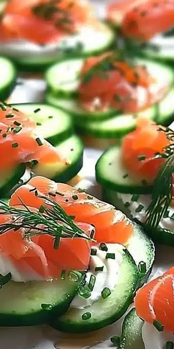 Smoked salmon cucumber rounds topped with dill on a platter