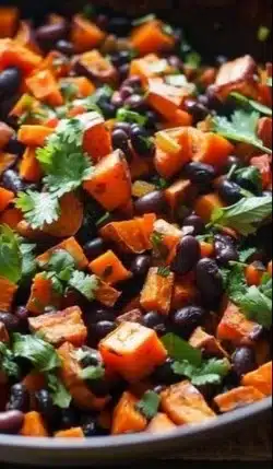 Colorful sweet potato black bean skillet with spices and garnishes