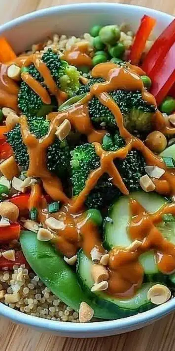 Colorful Thai Peanut Veggie Bowls with fresh vegetables and peanut sauce