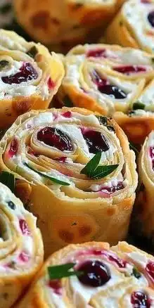 Delicious festive cranberry feta pinwheels served on a platter